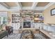 Cozy living room featuring a stone fireplace, custom built-ins, and stylish decor at 191 Grackle Ln., Pawleys Island, SC 29585
