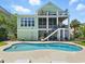 Back of home featuring an in-ground pool, screened in porch on two levels, and an elevated deck at 191 Grackle Ln., Pawleys Island, SC 29585