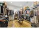 Spacious walk-in closet with wooden floors, custom shelving, hanging racks and bench seating at 191 Grackle Ln., Pawleys Island, SC 29585