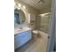 Bright bathroom featuring a large mirror, vanity, and shower-tub combo at 1980 Bent Grass Dr. # F, Surfside Beach, SC 29575