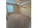 Carpeted bedroom featuring a ceiling fan, window, and small floating shelves at 1980 Bent Grass Dr. # F, Surfside Beach, SC 29575