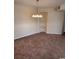 Dining room featuring a chandelier, carpeted floors, and built-in shelves at 1980 Bent Grass Dr. # F, Surfside Beach, SC 29575