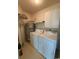 Functional laundry room features a washer, dryer, and water heater with built-in storage shelves at 1980 Bent Grass Dr. # F, Surfside Beach, SC 29575