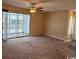 Spacious living room featuring a ceiling fan and access to a screened porch at 1980 Bent Grass Dr. # F, Surfside Beach, SC 29575