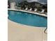 Community pool with lounge chairs and umbrella-covered tables for relaxing in the sun at 1980 Bent Grass Dr. # F, Surfside Beach, SC 29575