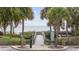 Boardwalk access to the beach, framed by lush palm trees, offering a scenic path to the ocean at 2001 S Ocean Blvd. # 815, Myrtle Beach, SC 29577