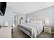 Bright bedroom with coastal decor featuring a queen bed, soft blue walls and stylish furnishings at 2001 S Ocean Blvd. # 815, Myrtle Beach, SC 29577