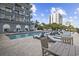 Outdoor pool with chairs and tables, perfect for relaxation with ocean views, located next to the building at 2001 S Ocean Blvd. # 815, Myrtle Beach, SC 29577