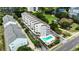 Aerial view of condo building with community pool and surrounding lush landscaping at 211 N Hillside Dr. # 204, North Myrtle Beach, SC 29582