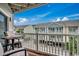 Balcony with seating overlooking well-maintained townhomes at 211 N Hillside Dr. # 204, North Myrtle Beach, SC 29582