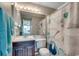Bathroom featuring a vanity with dark wood cabinets and a shower with coastal-themed curtain at 211 N Hillside Dr. # 204, North Myrtle Beach, SC 29582