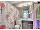 Bathroom featuring a flamingo-themed shower curtain, a vanity, and ample lighting at 211 N Hillside Dr. # 204, North Myrtle Beach, SC 29582