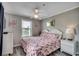 Relaxing bedroom with flamingo-themed decor, a ceiling fan, and bright natural light at 211 N Hillside Dr. # 204, North Myrtle Beach, SC 29582