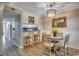 Well-lit dining area with a round table, decorative mirror, bar seating, and modern light fixture at 211 N Hillside Dr. # 204, North Myrtle Beach, SC 29582