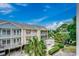 Multi-story condo building with balconies, lush landscaping and a sparkling community pool at 211 N Hillside Dr. # 204, North Myrtle Beach, SC 29582