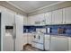 Well-organized kitchen featuring white cabinets, a microwave, and modern appliances at 211 N Hillside Dr. # 204, North Myrtle Beach, SC 29582