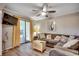 Well-lit living room with sliding glass door access to screened porch at 211 N Hillside Dr. # 204, North Myrtle Beach, SC 29582