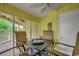 Screened porch with table and chairs at 211 N Hillside Dr. # 204, North Myrtle Beach, SC 29582