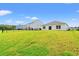 The large backyard has lush grass and fence views of neighboring homes from the rear of the property at 211 Pine Forest Dr., Conway, SC 29526