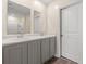 The bathroom includes double sinks, light countertops, a large mirror, and grey cabinets at 211 Pine Forest Dr., Conway, SC 29526