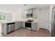 The kitchen offers stainless steel appliances, light countertops, light grey cabinets, and wood floor at 211 Pine Forest Dr., Conway, SC 29526