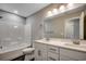 Well-lit bathroom with dual sinks, white cabinets, and a shower-tub combination at 211A 15Th Ave. S, Surfside Beach, SC 29575