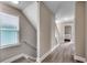 Hallway features a staircase to the left, plank flooring, neutral wall color and white trim throughout at 211A 15Th Ave. S, Surfside Beach, SC 29575
