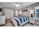 Comfortable bedroom with a white paneled headboard, soft lighting, and a ceiling fan at 211B 15Th Ave. S, Surfside Beach, SC 29575