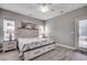 Bright bedroom features wood-look floors, neutral walls, and a decorative painting above the bed at 211B 15Th Ave. S, Surfside Beach, SC 29575