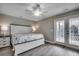 Light-filled bedroom with modern ceiling fan and easy access to a private outdoor balcony at 211B 15Th Ave. S, Surfside Beach, SC 29575
