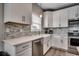 Bright kitchen features white cabinets, stainless steel appliances, and stylish backsplash at 211B 15Th Ave. S, Surfside Beach, SC 29575