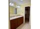 Well-lit bathroom with dual sinks, wood cabinets, and a walk-in closet at 216 Walden Lake Rd., Conway, SC 29526