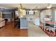 Bright kitchen with bar seating overlooking the kitchen with updated appliances and white cabinetry, open to the living area at 216 Walden Lake Rd., Conway, SC 29526