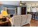 Inviting living room featuring a ceiling fan, neutral furnishings, and a breakfast bar leading to the kitchen at 216 Walden Lake Rd., Conway, SC 29526