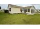 Bright sunroom addition with many windows and a sliding glass door with a concrete patio area in the backyard at 216 Walden Lake Rd., Conway, SC 29526
