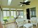 Sunroom with lots of windows and white wicker furniture at 216 Walden Lake Rd., Conway, SC 29526