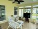 Sunroom with lots of windows and white wicker furniture at 216 Walden Lake Rd., Conway, SC 29526