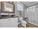 Well-appointed bathroom with a decorative mirror, a walk-in shower, and neutral color palette at 24 Jerry Ct., Pawleys Island, SC 29585