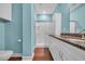 Well-lit bathroom featuring a granite vanity and a glass shower surrounded by eye-catching blue walls at 24 Jerry Ct., Pawleys Island, SC 29585