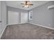 Neutral bedroom featuring plush carpeting, dual closets and a window with blinds, and an AC unit at 24 Jerry Ct., Pawleys Island, SC 29585