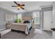 Comfortable bedroom boasts neutral tones, a ceiling fan, and plush carpeting at 24 Jerry Ct., Pawleys Island, SC 29585