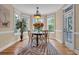 Breakfast nook bathed in natural light, features a table set for four guests, and hardwood floors at 24 Jerry Ct., Pawleys Island, SC 29585