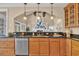 Kitchen view into the living room with granite countertops, stainless steel appliances, and wood cabinets at 24 Jerry Ct., Pawleys Island, SC 29585