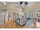 Bright living room features a soaring ceiling, hardwood floors, stairs and stylish neutral decor at 24 Jerry Ct., Pawleys Island, SC 29585