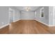 Neutral living room featuring wood flooring, a ceiling fan and multiple windows that allow natural light at 24 Jerry Ct., Pawleys Island, SC 29585