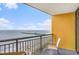 Enjoy ocean views from this condo balcony with a table and chairs at 2600 N Ocean Blvd. # 1406, Myrtle Beach, SC 29577