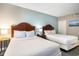 Bedroom showcasing two beds, side tables and accent blue walls at 2600 N Ocean Blvd. # 1406, Myrtle Beach, SC 29577