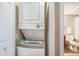 Stacked white washer and dryer with access to the main bathroom at 2600 N Ocean Blvd. # 1406, Myrtle Beach, SC 29577