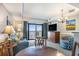 Open floor plan with dinette table, blue couch, and ocean view balcony at 2600 N Ocean Blvd. # 1406, Myrtle Beach, SC 29577