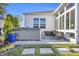 A hot tub sits on a stone patio next to a sunroom, with a blue planter adding a pop of color at 2653 Orion Loop, Myrtle Beach, SC 29577
